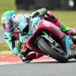 Motorcycle rider leaning into a high-speed turn